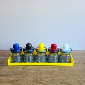 Set of 5 vintage 1980s plastic spice jars containers with colored lids in rack.